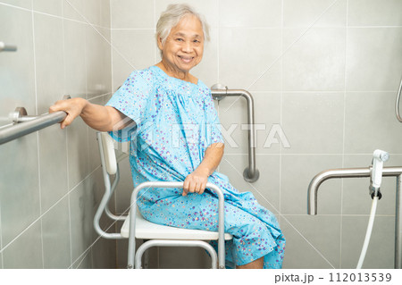 Asian elderly woman patient use toilet bathroom handle security in nursing hospital, healthy strong medical concept. 112013539