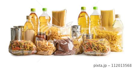 Foodstuff for donation, storage and delivery. Various food, pasta, cooking oil and canned food in cardboard box. Foodstuff for donation, storage and delivery. Various food, pasta, cooking oil and canned food in cardboard box. 112013568