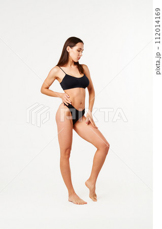 Full length portrait of beautiful sporty sensual woman in black underwear on white 112014169