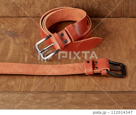 Wooden stand featuring leather belts with personalized embossment and engraving 112014347