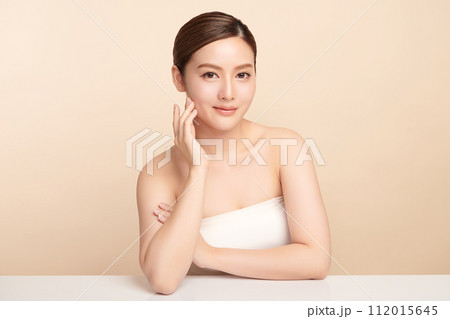 Beautiful young asian woman with clean fresh skin on beige background, Face care, Facial treatment, Cosmetology, beauty and spa, Asian women portrait. 112015645