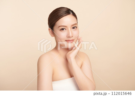 Beautiful young asian woman with clean fresh skin on beige background, Face care, Facial treatment, Cosmetology, beauty and spa, Asian women portrait. 112015646