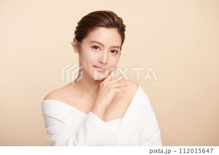 Beautiful young asian woman with clean fresh skin on beige background, Face care, Facial treatment, Cosmetology, beauty and spa, Asian women portrait. 112015647