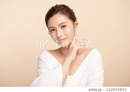 Beautiful young asian woman with clean fresh skin on beige background, Face care, Facial treatment, Cosmetology, beauty and spa, Asian women portrait. 112015651
