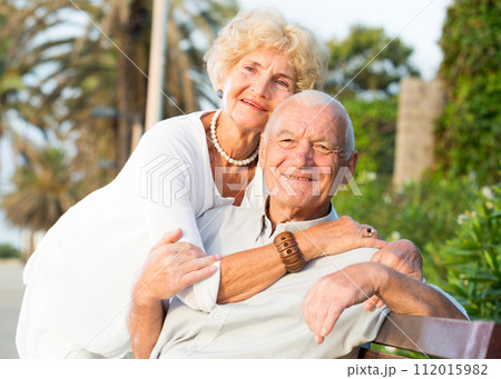 smiling male and female hugging 112015982