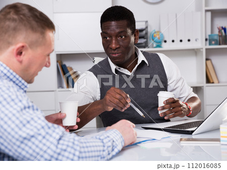Interracial two male in the office filling up documents Interracial two male in the office filling up documents 112016085