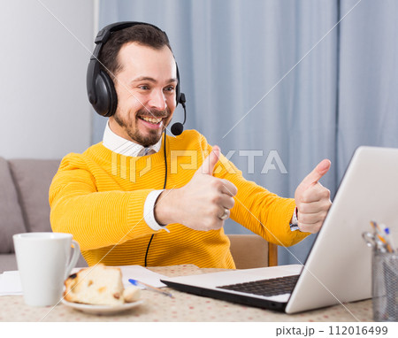 Man studying remotely at home Man studying remotely at home 112016499