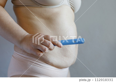 Medicine, overweight, weight loss and diet concept. Female stomanch and semaglutide Medicine, overweight, weight loss and diet concept. Female stomanch and semaglutide 112018331