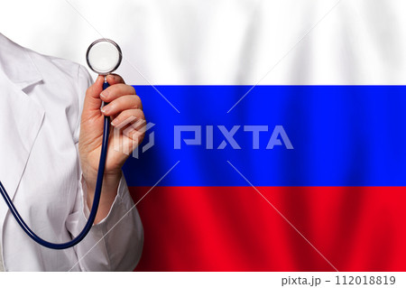 Russian doctor's hand with stethoscope on the background of flag of Russia Medicine Russian doctor's hand with stethoscope on the background of flag of Russia Medicine 112018819
