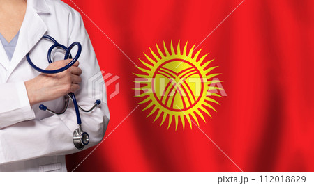Kyrgyz medicine and healthcare concept. Doctor close up against flag of Kyrgyzstan background 112018829