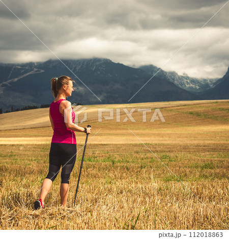 Young woman hiking in the mountains Young woman hiking in the mountains 112018863