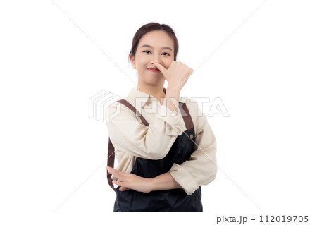 Portrait smiling young asian woman wearing apron showing thumbs up with hand isolated. Portrait smiling young asian woman wearing apron showing thumbs up with hand isolated. 112019705