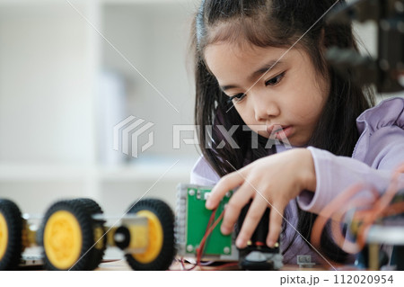 STEM education concept. Asian young girl learning robot design. 112020954