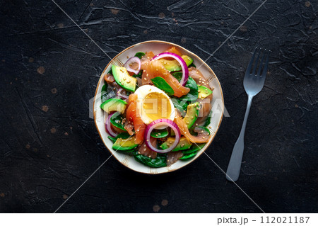 Salmon, avocado and egg salad with fresh leaves and onions Salmon, avocado and egg salad with fresh leaves and onions 112021187