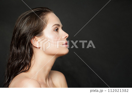 Lovely woman with massage or surgery lines on her face. 112021382