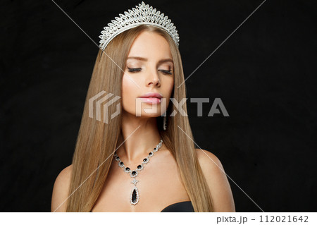 Nice woman with make-up and long healthy hair wearing diamond and sapphire jewelry necklace  112021642