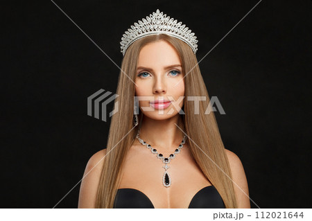 Glamorous woman with make-up and long healthy hair wearing diamond and sapphire jewelry necklace Glamorous woman with make-up and long healthy hair wearing diamond and sapphire jewelry necklace 112021644