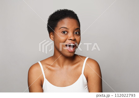 Surprised african american female model with healthy fresh clear dark skin posing  112022793