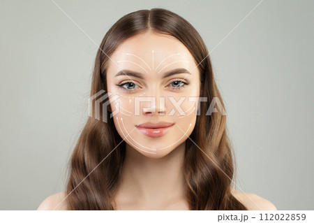 Grid of lines showing facial lifting effect on fresh skin of beautiful young woman  112022859