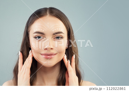 Plastic surgery concept. Woman face with marks and arrows on skin closeup Plastic surgery concept. Woman face with marks and arrows on skin closeup 112022861