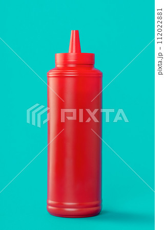 Ketchup plastic bottle isolated on a blue background 112022881