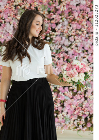 Pretty healthy woman smiling and holding colorful pink color flower bouquet on floral spring 112023273