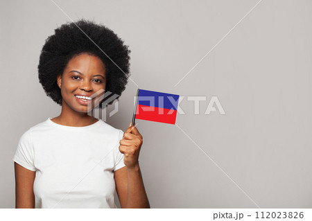 Haitian woman holding flag of Haiti Education, business, citizenship and patriotism concept Haitian woman holding flag of Haiti Education, business, citizenship and patriotism concept 112023826