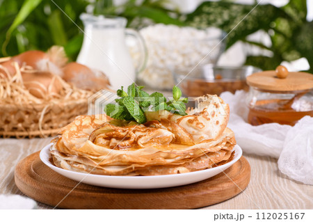 Homemade thin crepe (pancakes) with honey Homemade thin crepe (pancakes) with honey 112025167