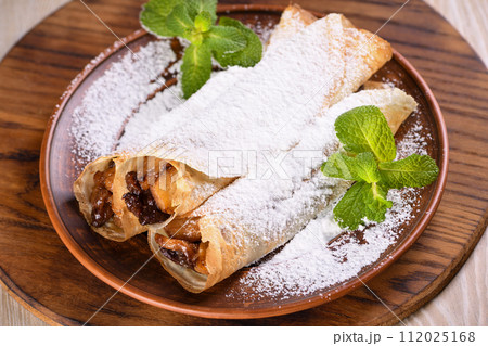 Homemade thin crepe (pancakes) with apple filling Homemade thin crepe (pancakes) with apple filling 112025168