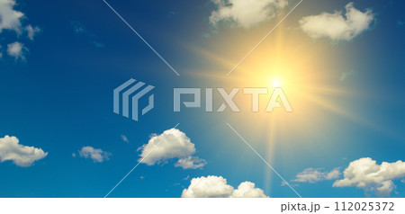 Bright sun on beautiful blue sky with white clouds. 112025372