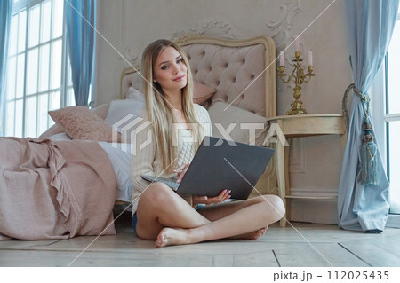 Pretty woman student with laptop at home Pretty woman student with laptop at home 112025435