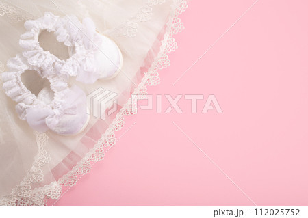Christening background with baptism baby shoes on pink background Christening background with baptism baby shoes on pink background 112025752