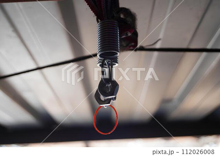 Metal Spring and Clip Attached to a Wire Indoors 112026008
