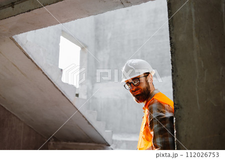Young businessman construction standing on his workplace on the construction site Young businessman construction standing on his workplace on the construction site 112026753