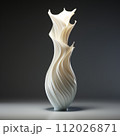Beautiful white slim vase with amazing curves standing on a gray background in the studio light. Thin bud vase with a wavy shape standing under white light. 112026871