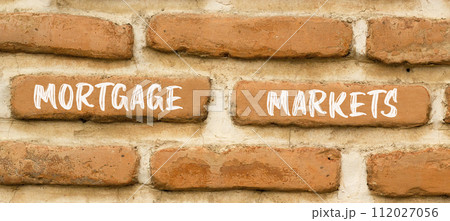 Mortgage markets symbol. Concept words Mortgage markets on beautiful brown brick wall. Beautiful brown brick wall background. Business mortgage markets concept. Copy space. 112027056
