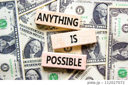 Anything is possible symbol. Concept words Anything is possible on beautiful wooden blocks. Dollar bills. Beautiful dollar bills background. Business anything possible concept. Copy space. 112027072