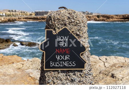 How to name your business symbol. Concept words How to name your business on beautiful blackboard. Beautiful stone sea background. How to name your business concept. Copy space. 112027118