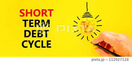 Short term debt cycle symbol. Concept words Short term debt cycle on beautiful yellow paper. Beautiful yellow background. Businessman hand. Business Short term debt cycle concept. Copy space Short term debt cycle symbol. Concept words Short term debt cycle on beautiful yellow paper. Beautiful yellow background. Businessman hand. Business Short term debt cycle concept. Copy space 112027128