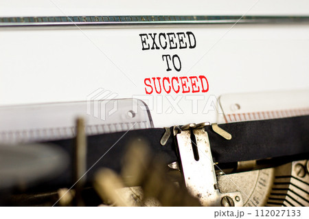 Exceed to succeed symbol. Concept words Exceed to succeed typed on beautiful old retro typewriter. Beautiful white paper background. Business and exceed to succeed concept. Copy space. 112027133