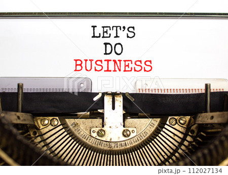 let is do business symbol. Concept words let is do business typed on beautiful old retro typewriter. Beautiful white paper background. let is do business concept. Copy space. let is do business symbol. Concept words let is do business typed on beautiful old retro typewriter. Beautiful white paper background. let is do business concept. Copy space. 112027134