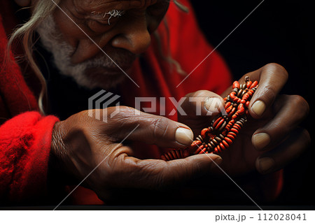 Elderly Craftsman Handcrafting Beaded Ornament Elderly Craftsman Handcrafting Beaded Ornament 112028041