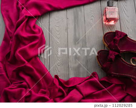 burgundy sandals wedge shawl shoes and bottle pink perfume. 112029285