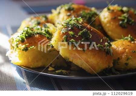 Close-up of garlic bread with parsley. Food photography for recipe and menu design Close-up of garlic bread with parsley. Food photography for recipe and menu design 112029619