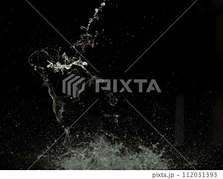 Throwing of Water splashes into drop water attack fluttering in wall floor and stop motion freeze shot. Splash Water for explosion texture graphic resource elements, black background isolated Throwing of Water splashes into drop water attack fluttering in wall floor and stop motion freeze shot. Splash Water for explosion texture graphic resource elements, black background isolated 112031393