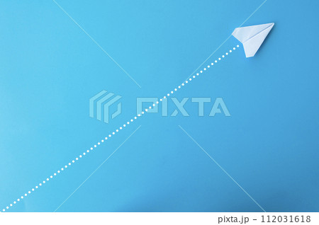 Top view of paper airplane with straight line dots on blue background. Top view of paper airplane with straight line dots on blue background. 112031618