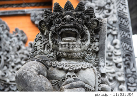 The traditional Balinese stone statue decorated in Pura Taman Ayun the royal temple of Mengwi empire in Badung Regency, Bali, Indonesia. The traditional Balinese stone statue decorated in Pura Taman Ayun the royal temple of Mengwi empire in Badung Regency, Bali, Indonesia. 112033304