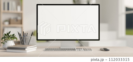 A computer desk in a contemporary home office features a white-screen computer mockup. 112033315