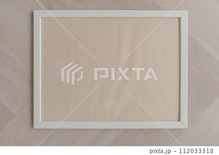 Top view of empty space of white photo frame, putting on wooden floor. 112033318