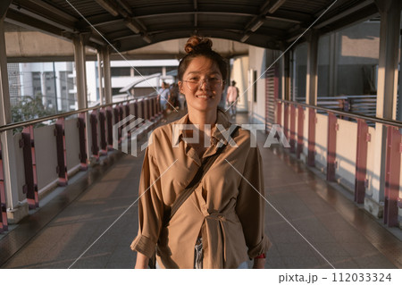 Ordinary asian salary woman walking on city bridge. Ordinary asian salary woman walking on city bridge. 112033324